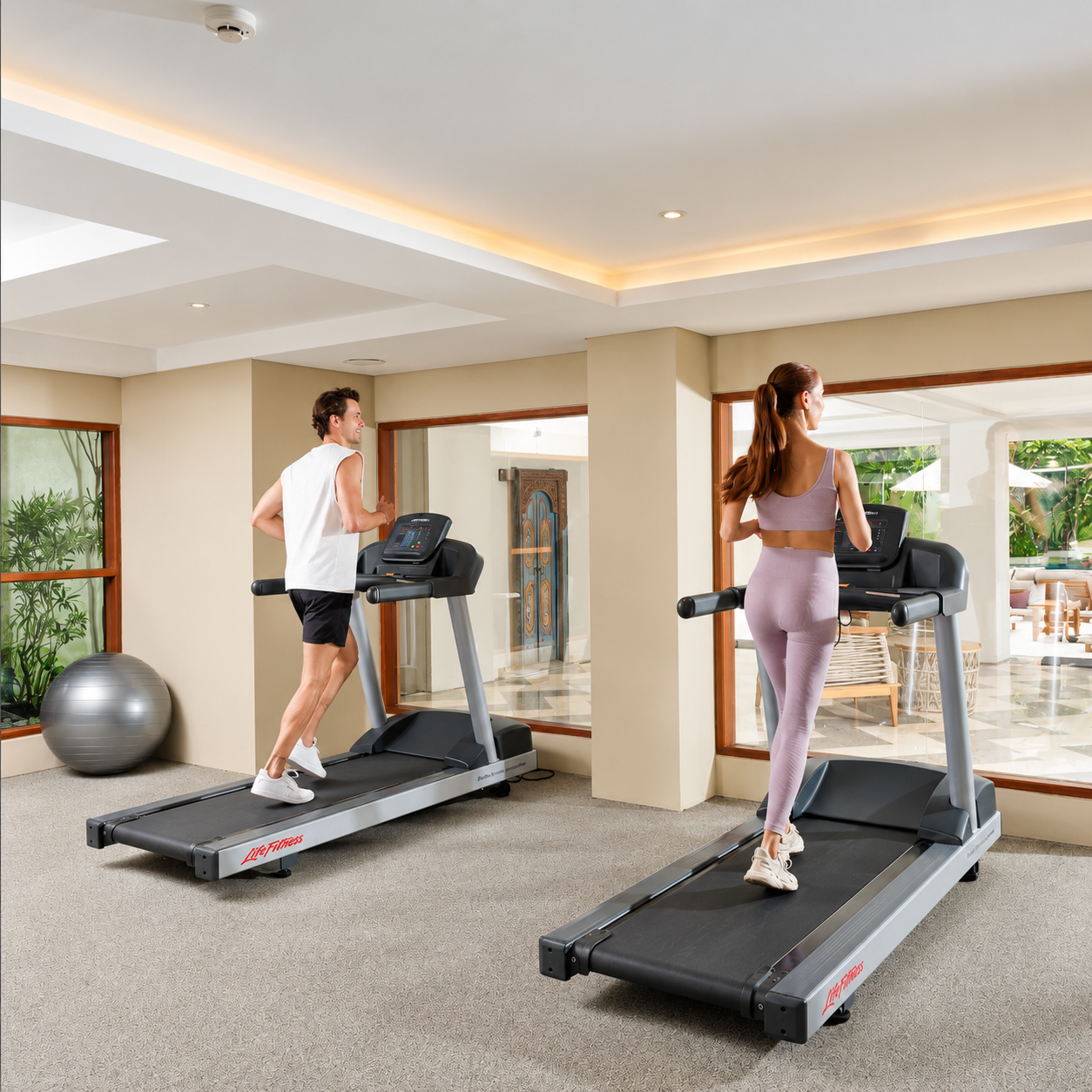 Guests working out with gym equipment in hotel fitness centre