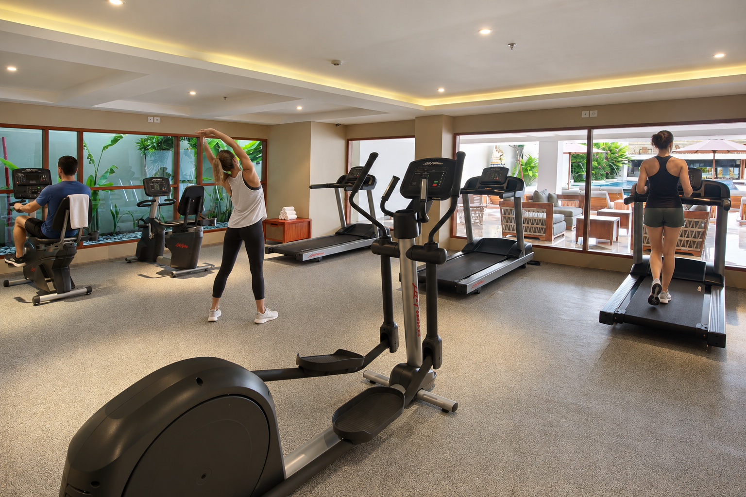 Guest exercising on treadmill in hotel gym