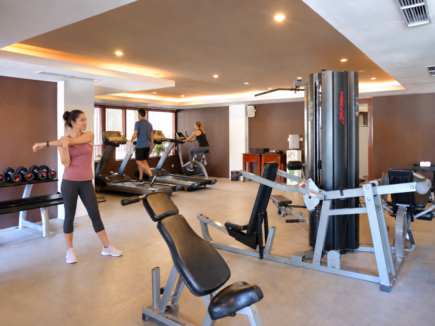 Woman exercising with dumbbells in a hotel gym