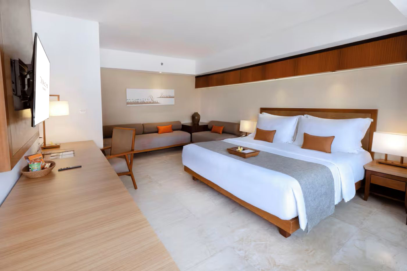Deluxe hotel room with a double bed and modern furnishings.