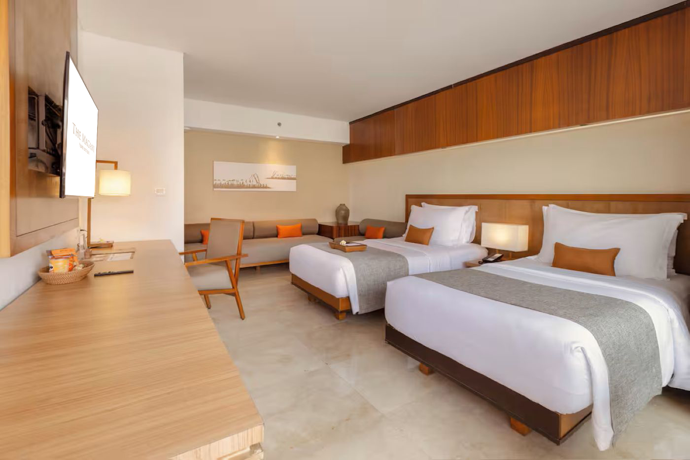 Deluxe twin room with two single beds and a seating area.